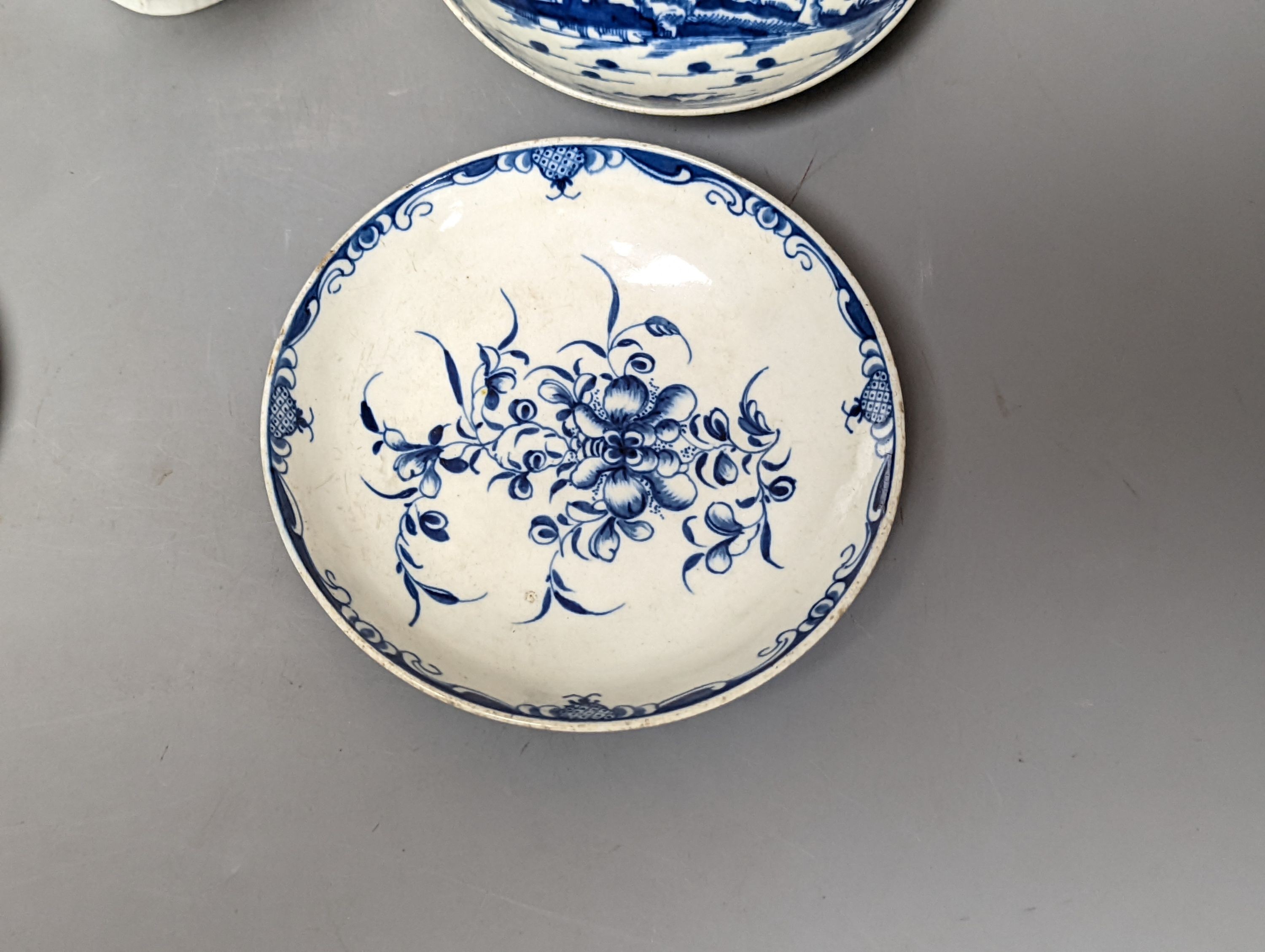 A Worcester blue and white sauceboat, two tea bowls and saucers, late 18th century and a Japanese single saucer. (7)